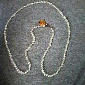Faux Pearl neck with a coin attached